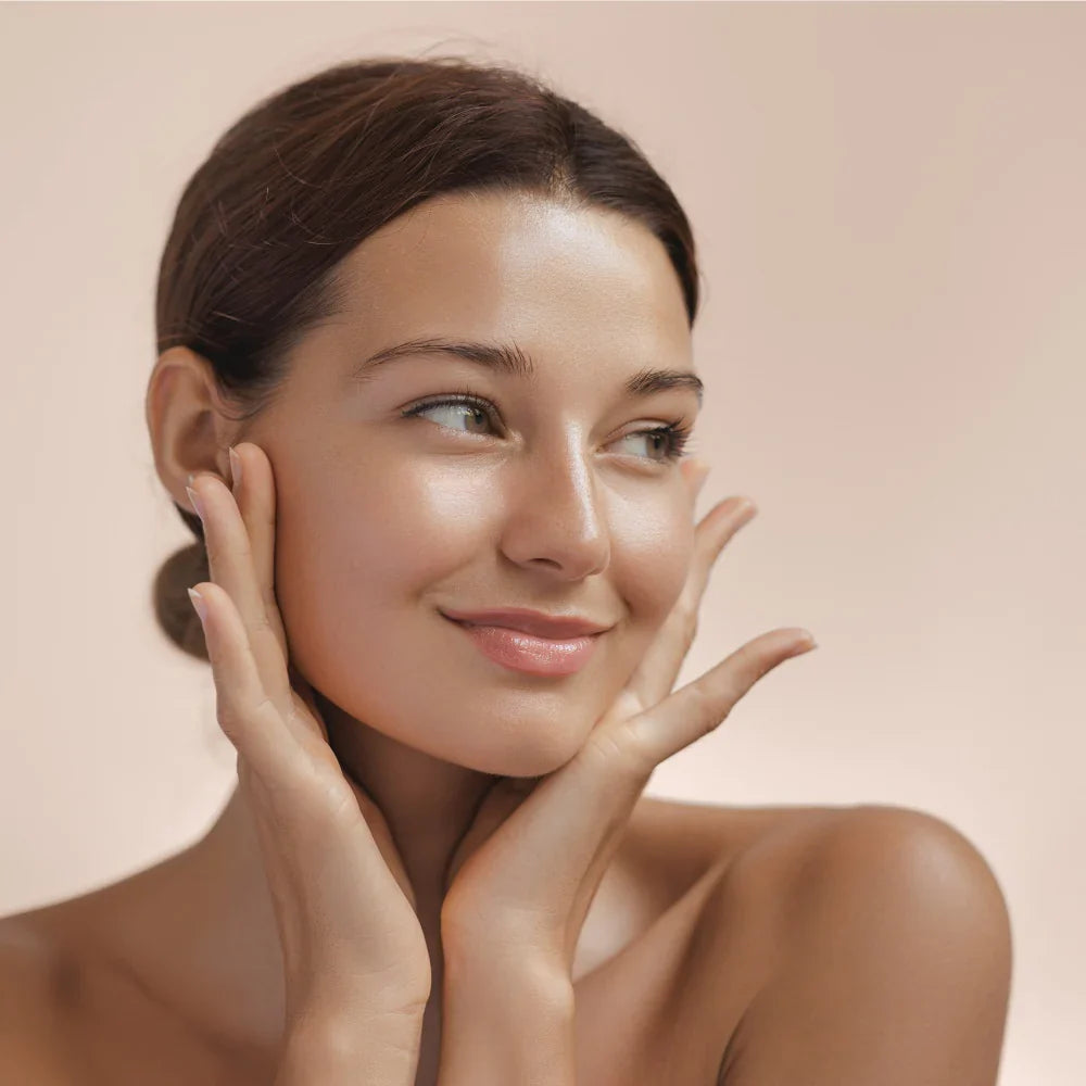Happy woman touching her smooth, radiant face after using PureSpin Multi-Function Cleansing Brush