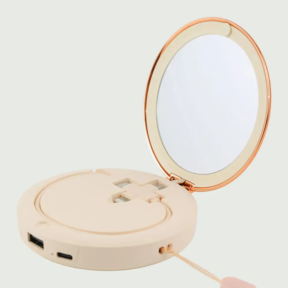 re-nū Smart Beauty Hand Warmer Power Bank displayed in the Beige color option showcasing its compact mirror and versatile charging cable.