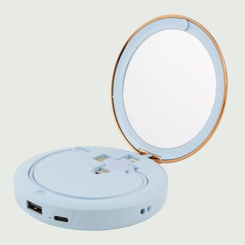 re-nū Smart Beauty Hand Warmer Power Bank displayed in the Blue color option showcasing its compact mirror and versatile charging cable.