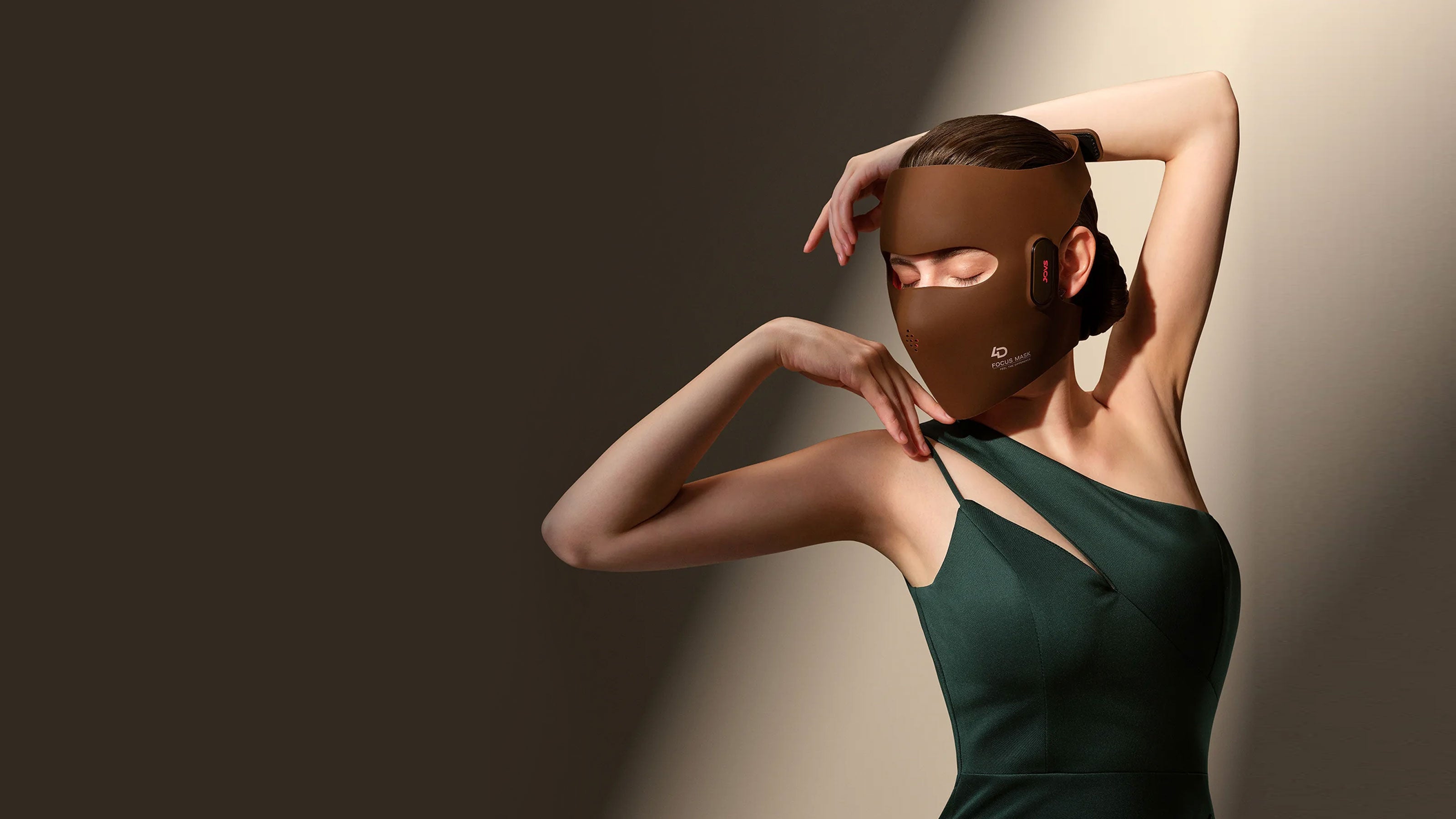 Glamorous woman wearing the 4D Laser Light Therapy Mask by re-nū and JOVS, designed to penetrate the skin to boost collagen and dramatically reduce facial wrinkles.