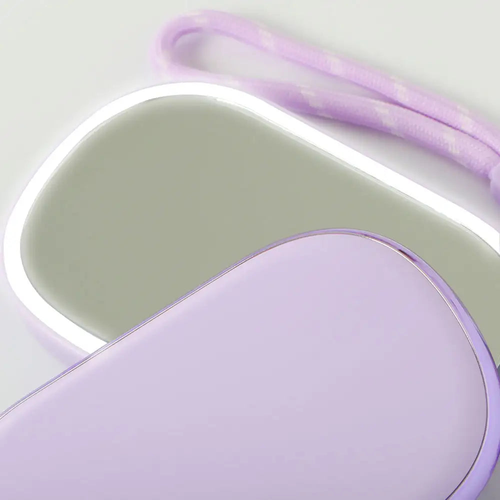 Open compact showing 1× and 2× magnetic mirrors with LED fill light off, Purple version