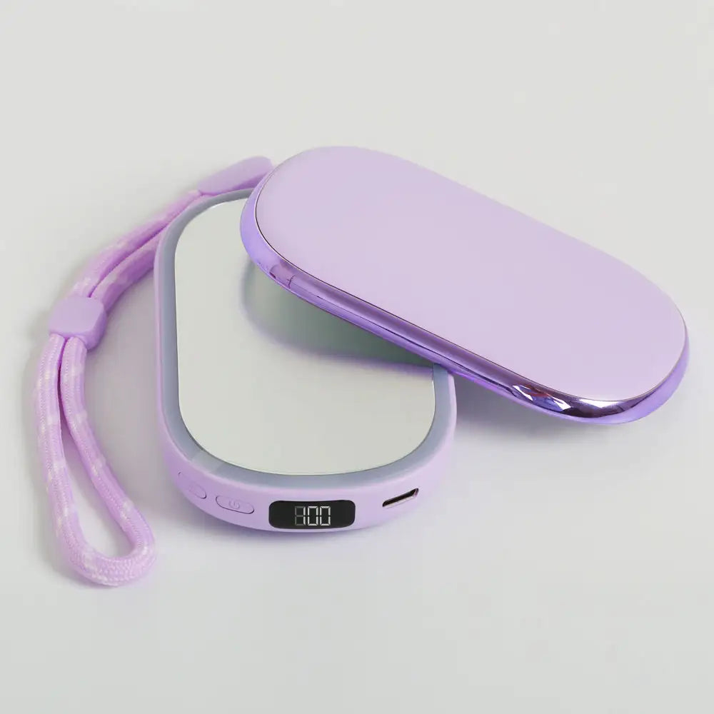 Open compact showing 1× and 2× magnetic mirrors with LED fill light off, Purple version