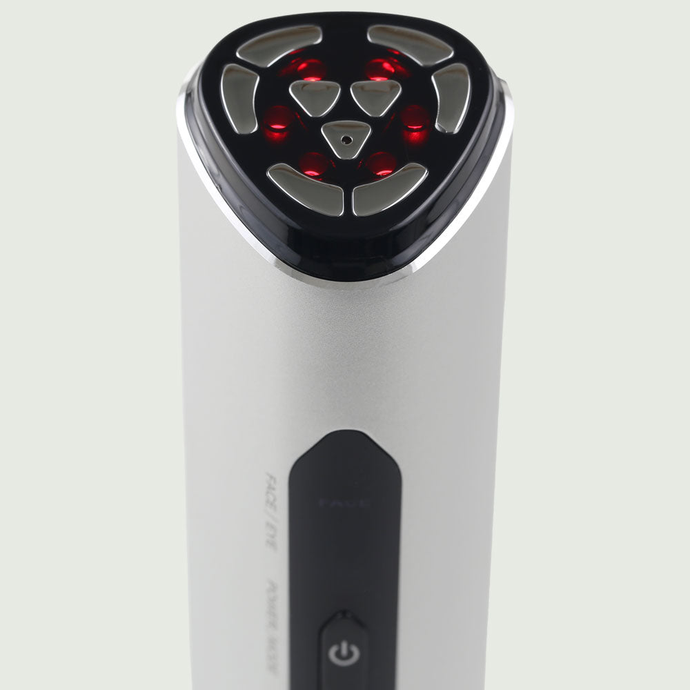 Close-up of the re-nū RF LED Microcurrent Device tip glowing during active treatment, showing dual EMS and RF action.
