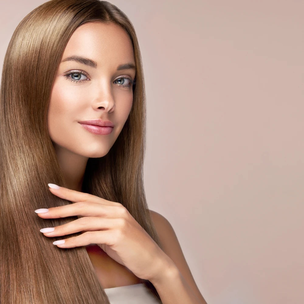 Relaxed woman smiling gently while running her hands through thick, healthy hair after using the Plasma Laser Hair Growth Comb – showcasing post-treatment volume and shine.