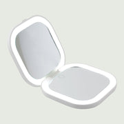 Open view of the Compact LED Pocket Mirror from re-nū Smart Beauty, featuring built-in cool LED lighting and a sleek, portable design