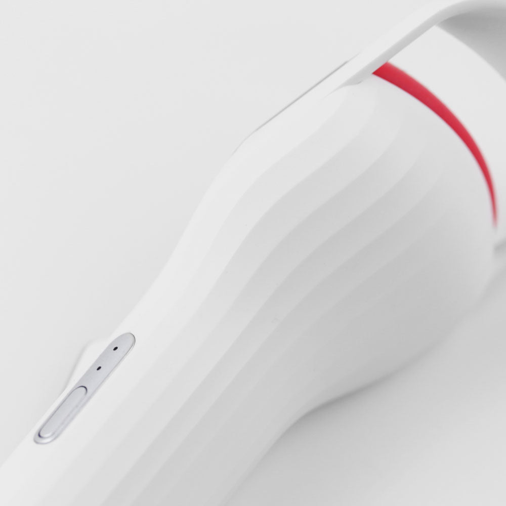 Side view of heated eyelash curler featuring sleek grip and button control, showcasing fast heat-up design