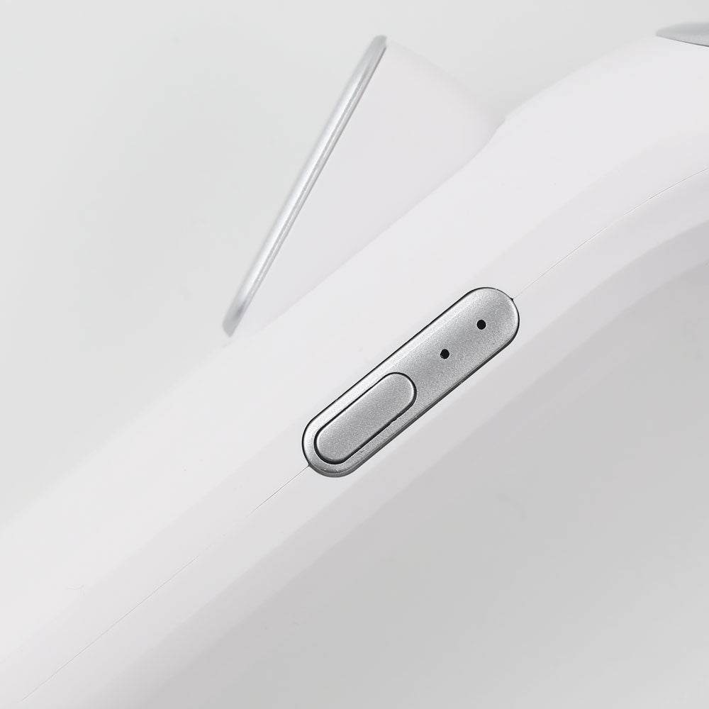 Close-up view of heated eyelash curler power button, highlighting safety design and user-friendly controls.