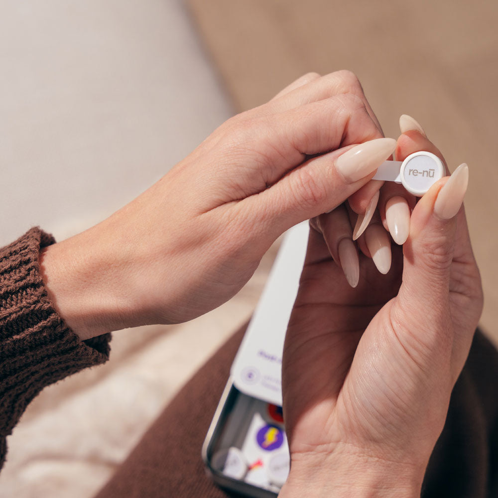 Woman holding GlowUp LED Patch in hand, about to open for application