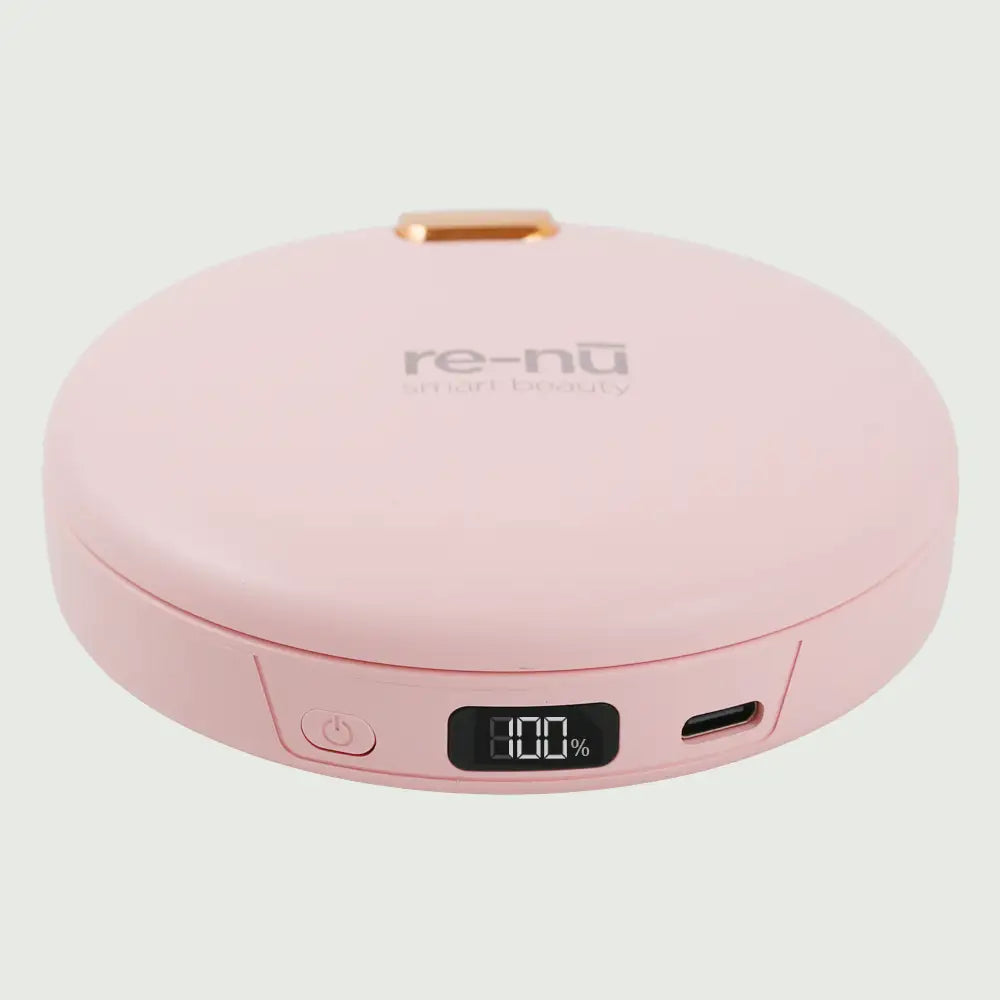 Pink re-nū LED Mirror + Power Bank with Digital Display shown closed on a flat surface