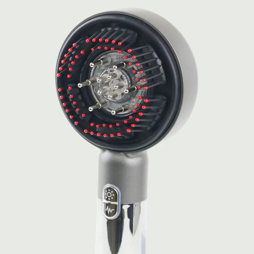 Closeup view of the LED Therapy Massage Comb showing bristles and essential oil ports for robust hair growth.