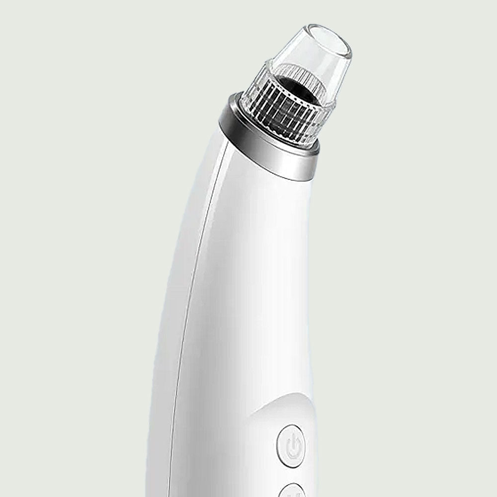 Close-up of the suction tip on the white Pore Cleanser with Heating, showing its sleek ergonomic design and power button.