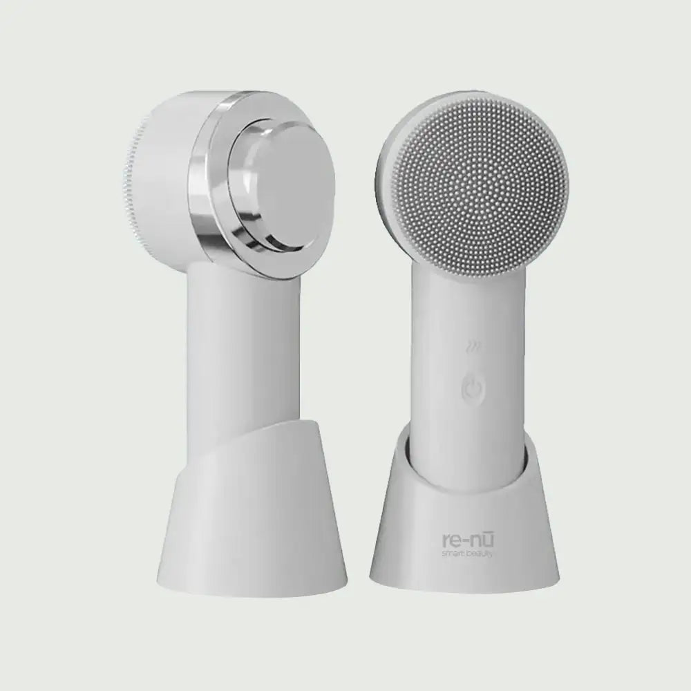 Front and back view of the PurePulse Elite Sonic Brush with Heat by re-nū sleek skincare device with medical-grade silicone bristles, featuring warming tip for deep pore cleansing and daily glow enhancement.