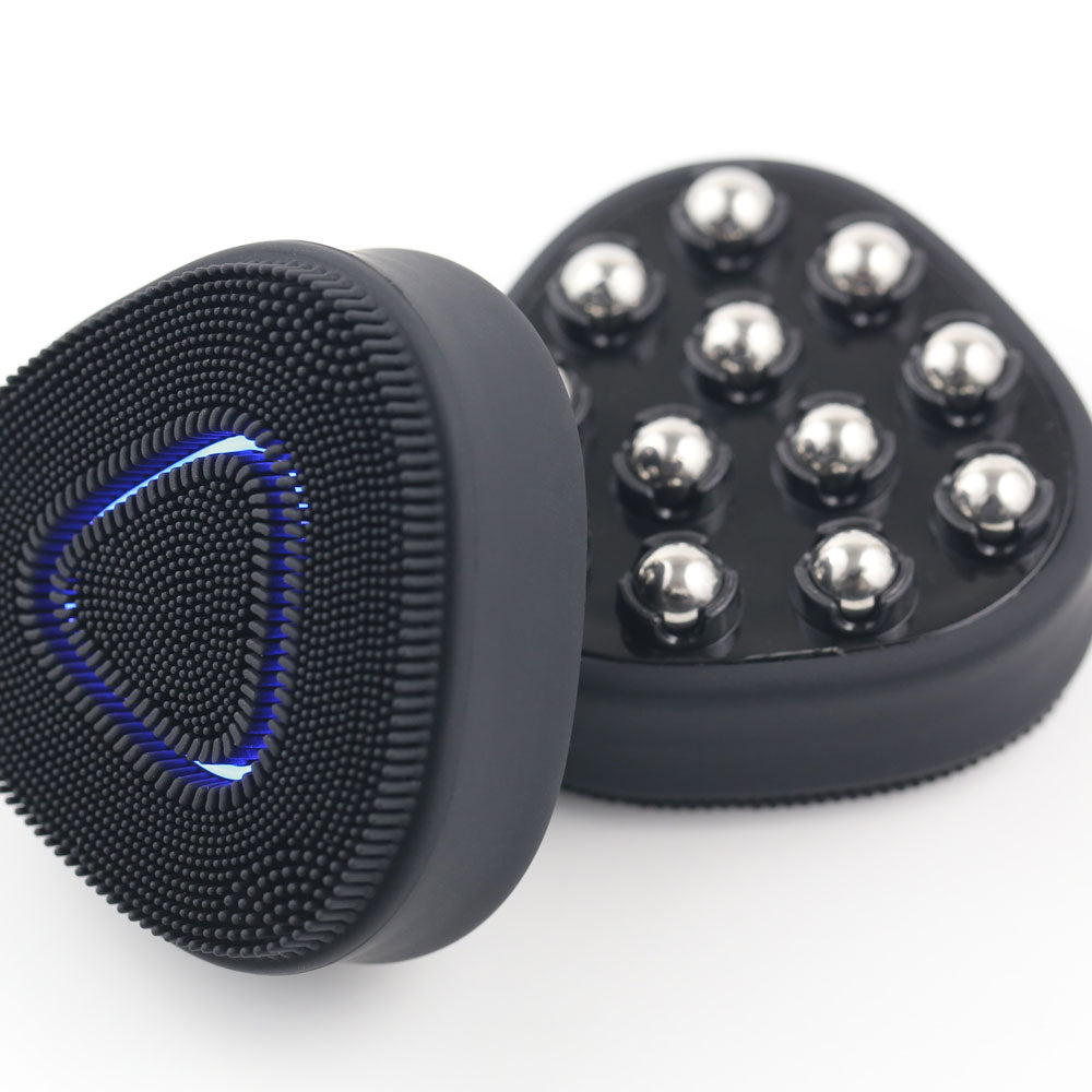 Side-by-side view of the black PurePulse Pro Sonic Cleansing Brush showing the front with soft silicone bristles and glowing blue LED ring, and the back featuring multiple metallic massage nodes for facial toning and circulation.