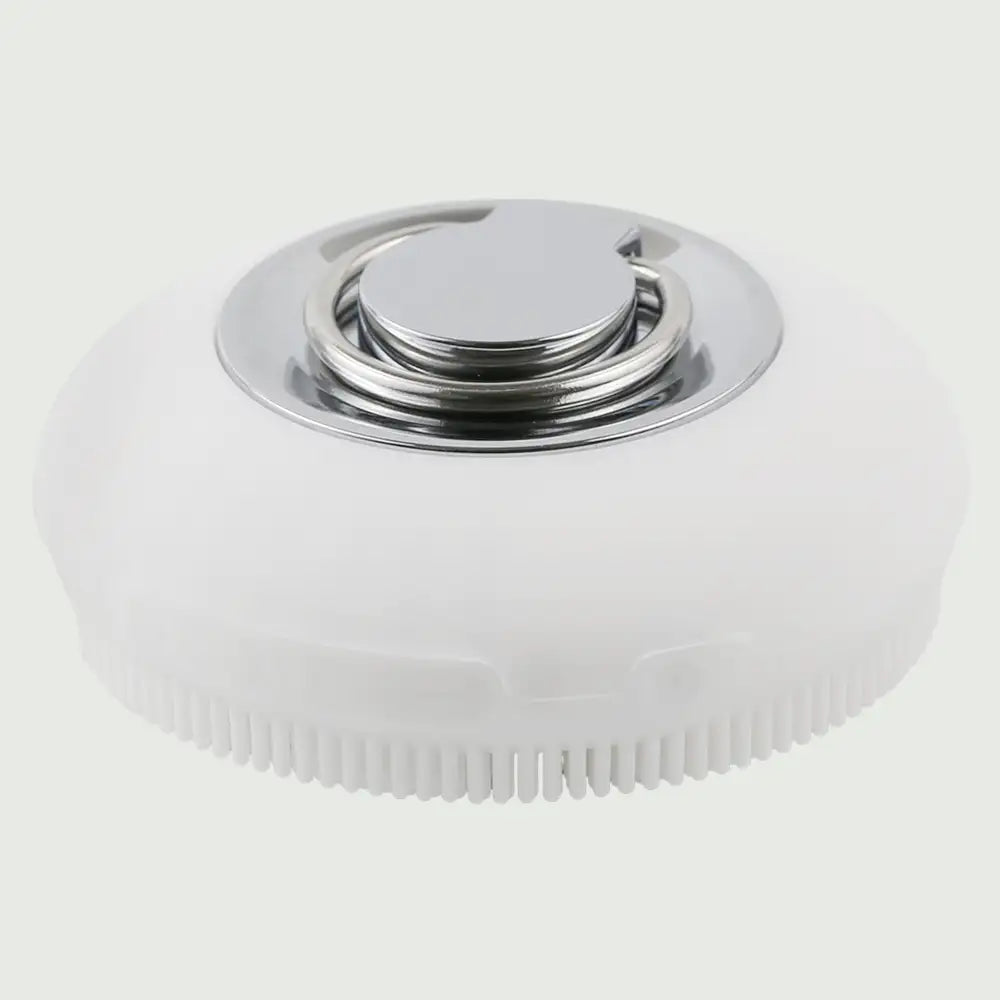 A top down view of the PurePulse Sonic Cleansing Brush showing it's textured bristles and a silver ring handle, for deep pore cleansing and gentle exfoliation.