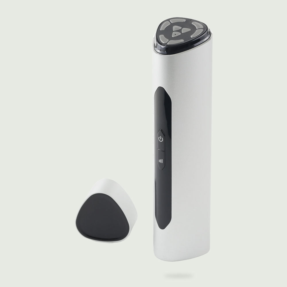 Front-facing image of the re-nū RF LED Microcurrent Face-Lifting Device with its lid removed and placed to the side, showcasing the treatment head and sleek, modern design.
