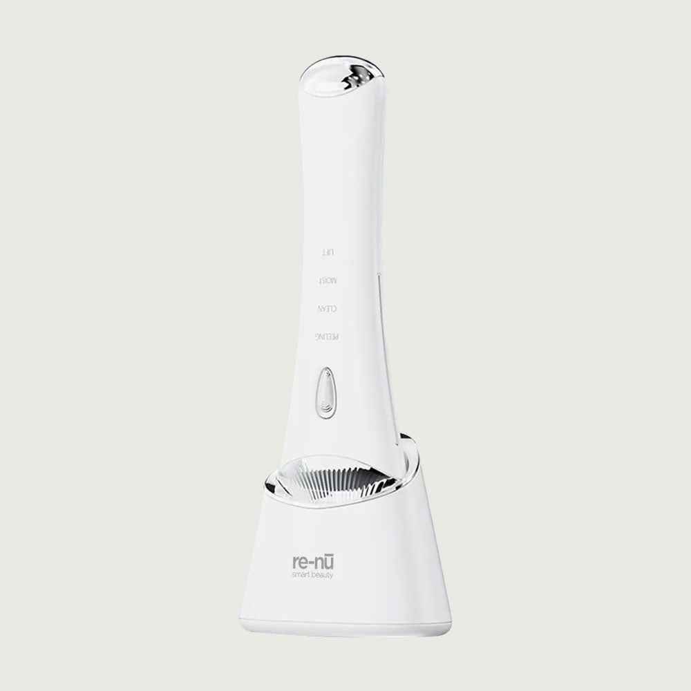 Ultrasonic Skin Scrubber fully seated in its UV wireless charging base, showcasing the full device design and home-use charging setup.