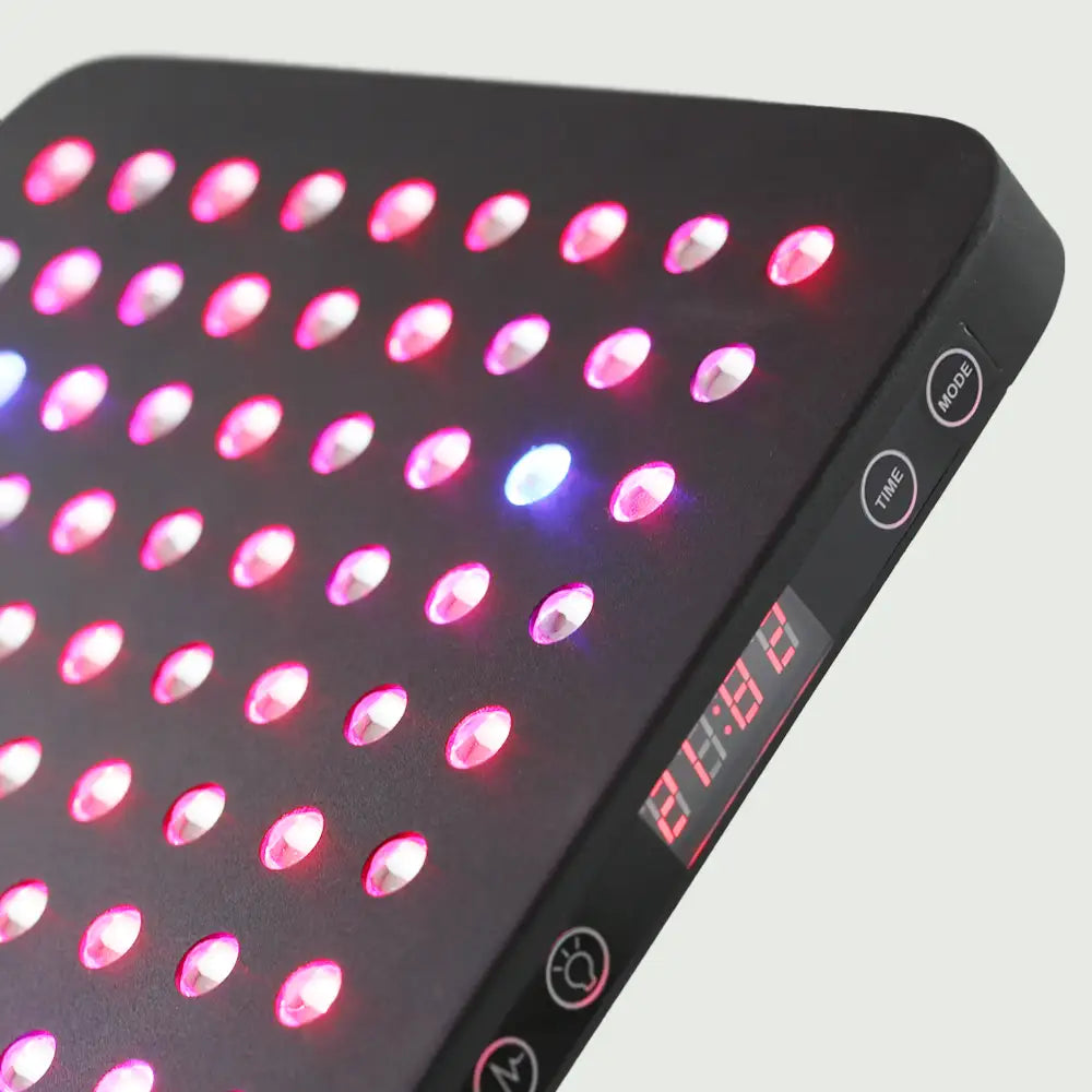 Close-up image of the LED Red Light Therapy Panel Elite - UltraThin, featuring rows of red and near-infrared, red, and blue lights emitting a steady glow—designed for at-home use to promote recovery with high-intensity, flicker-free illumination.
