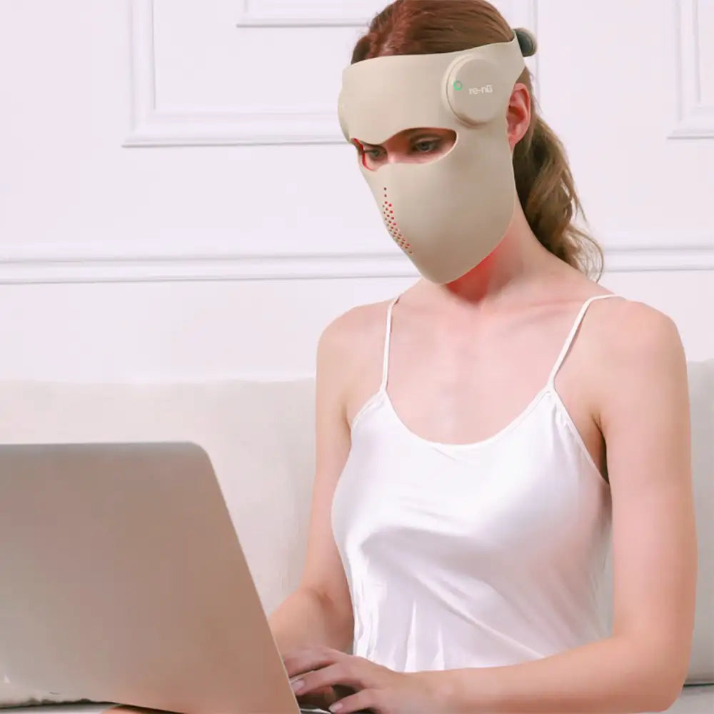 Woman wearing the 5D Mask Laser Mask during a skincare routine while at-home.