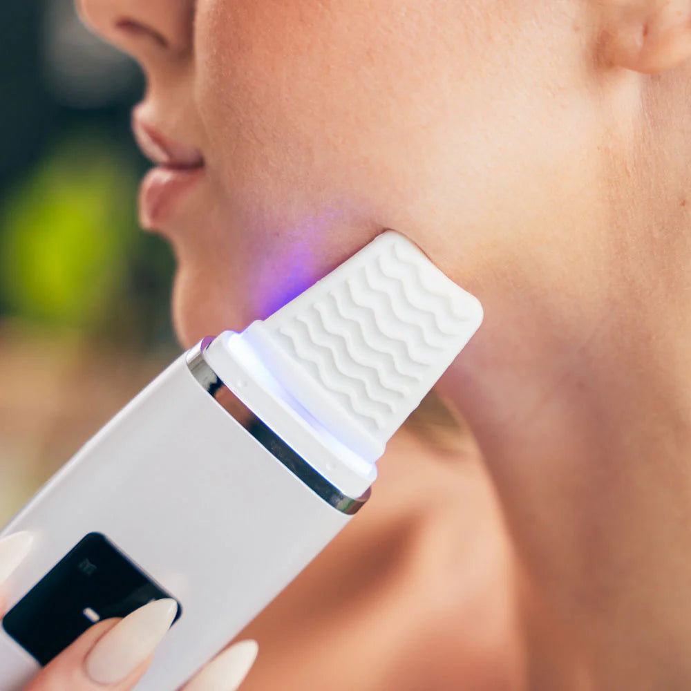 Model lifting jawline with facial scrubber for contour and glow
