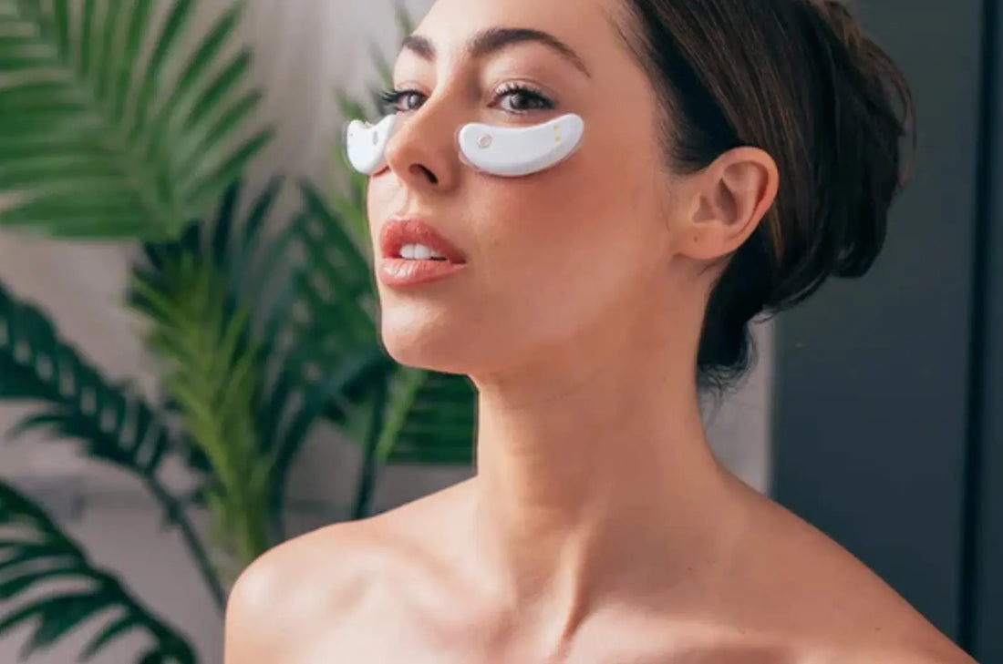 Woman using GlowUp Eye Pad at home – portable skincare anti-aging tool