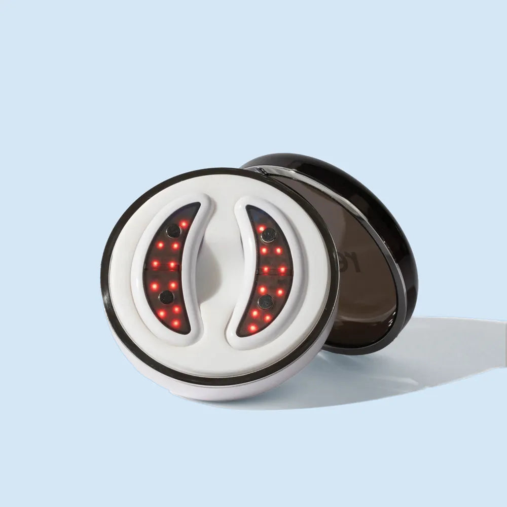 Front view of GlowUp LED/EMS Under Eye Anti-Aging Pads placed neatly in their sleek, round USB-C charging case.