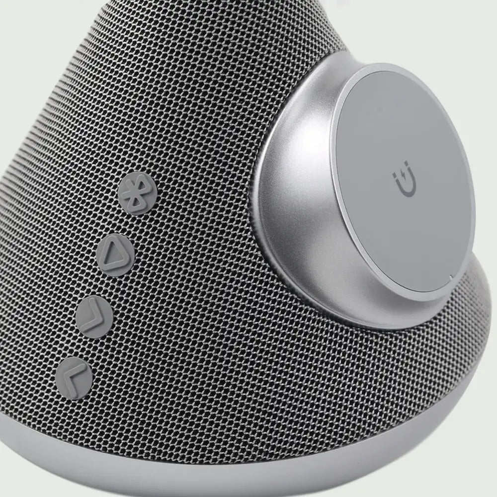 Side close-up of the re-nū 3-in-1 Smart Beauty Mirror, highlighting the built-in Bluetooth speaker, magnetic magnifier, wireless phone holder, and speaker control area.