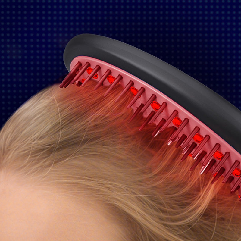 A woman uses a red comb to brush her hair, enhanced by laser light and EMS technology for improved hair health.