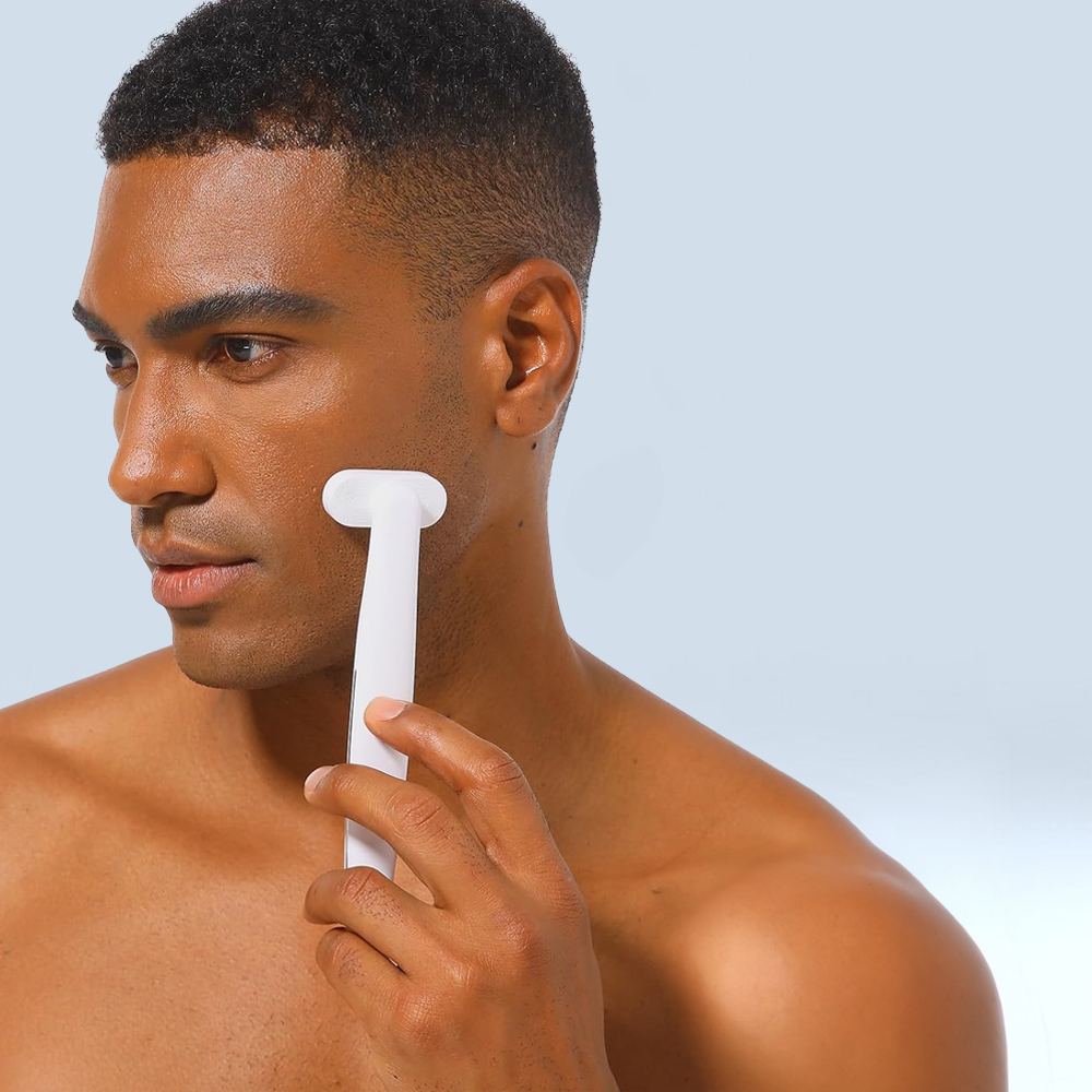 A man holds a white brush, preparing for a session of Mask LED Light Therapy