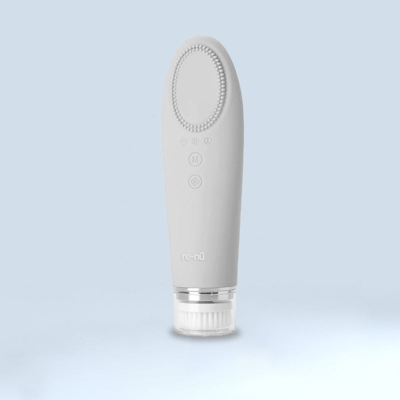 A white electric toothbrush on a blue background, featuring a mask for LED light therapy.