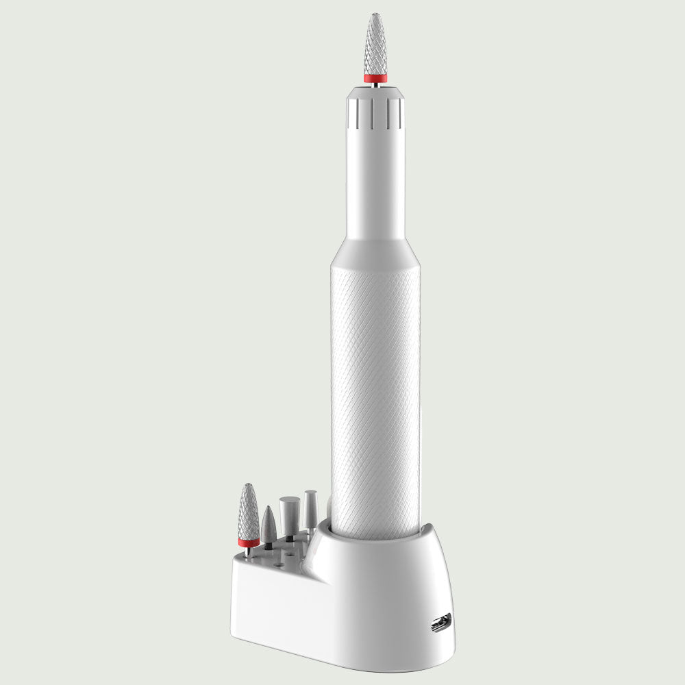 Rear angled view of re-nū Smart Beauty 7-in-1 Nail Drill charging base with USB-C port and five interchangeable manicure bits for buffing, filing, and polishing