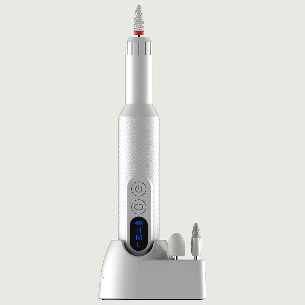 Front view of re-nū Smart Beauty 7-in-1 Electric Nail Drill Set with digital LED display, power and rotation buttons, and two interchangeable bits on a charging dock for at-home manicures
