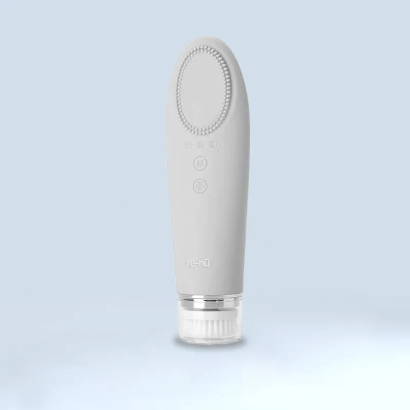 A white handheld skincare device with a silicone brush head, designed for deep pore cleansing and heat therapy, displayed on a light blue background.