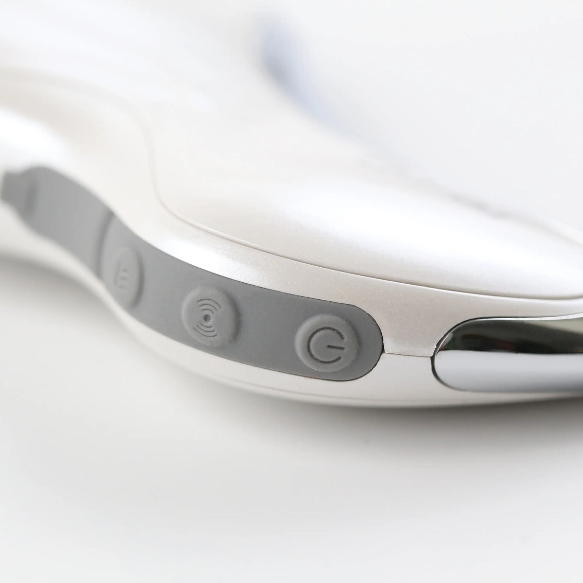 Close-up of the Heated Sonic Gua Sha Facial Massager controls, showing the power button and simple interface for easy operation.