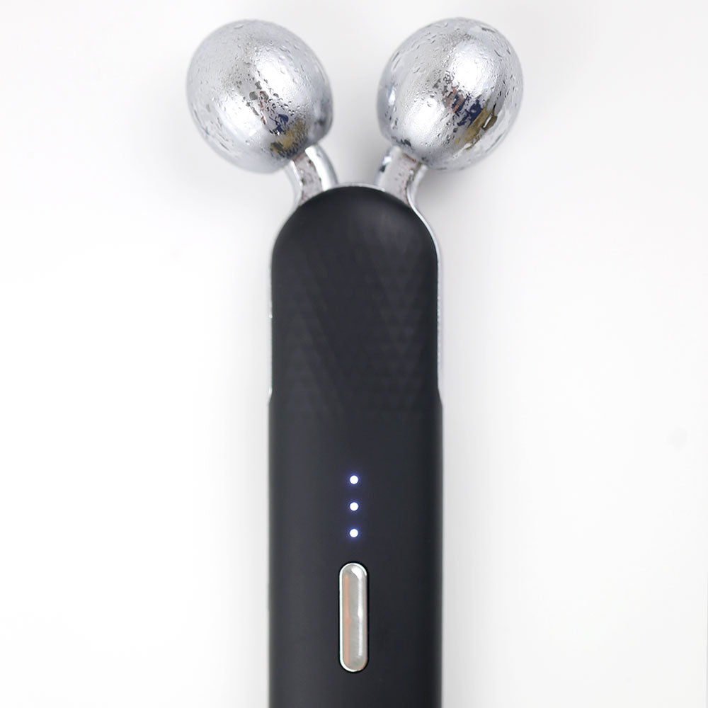 Detailed view of the dual-sphere EMS V-Roller on the re-nū Cold Therapy EMS Dual Roller, designed to lift, contour, and tone facial muscles through gentle microcurrent technology.