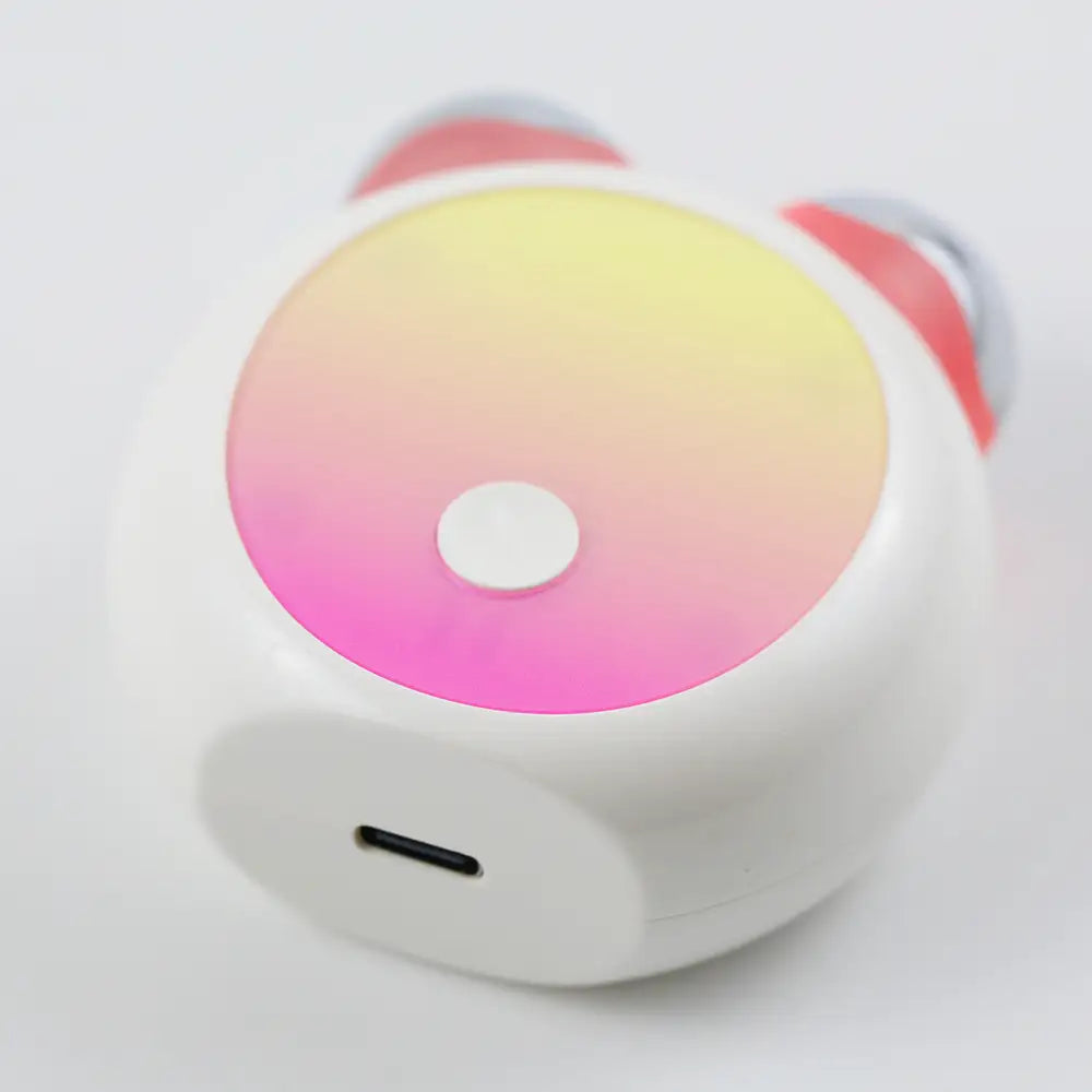 Close-up view of the compact LED Facial Toning Massager; flat view showing the easy to access USB-C charging port..