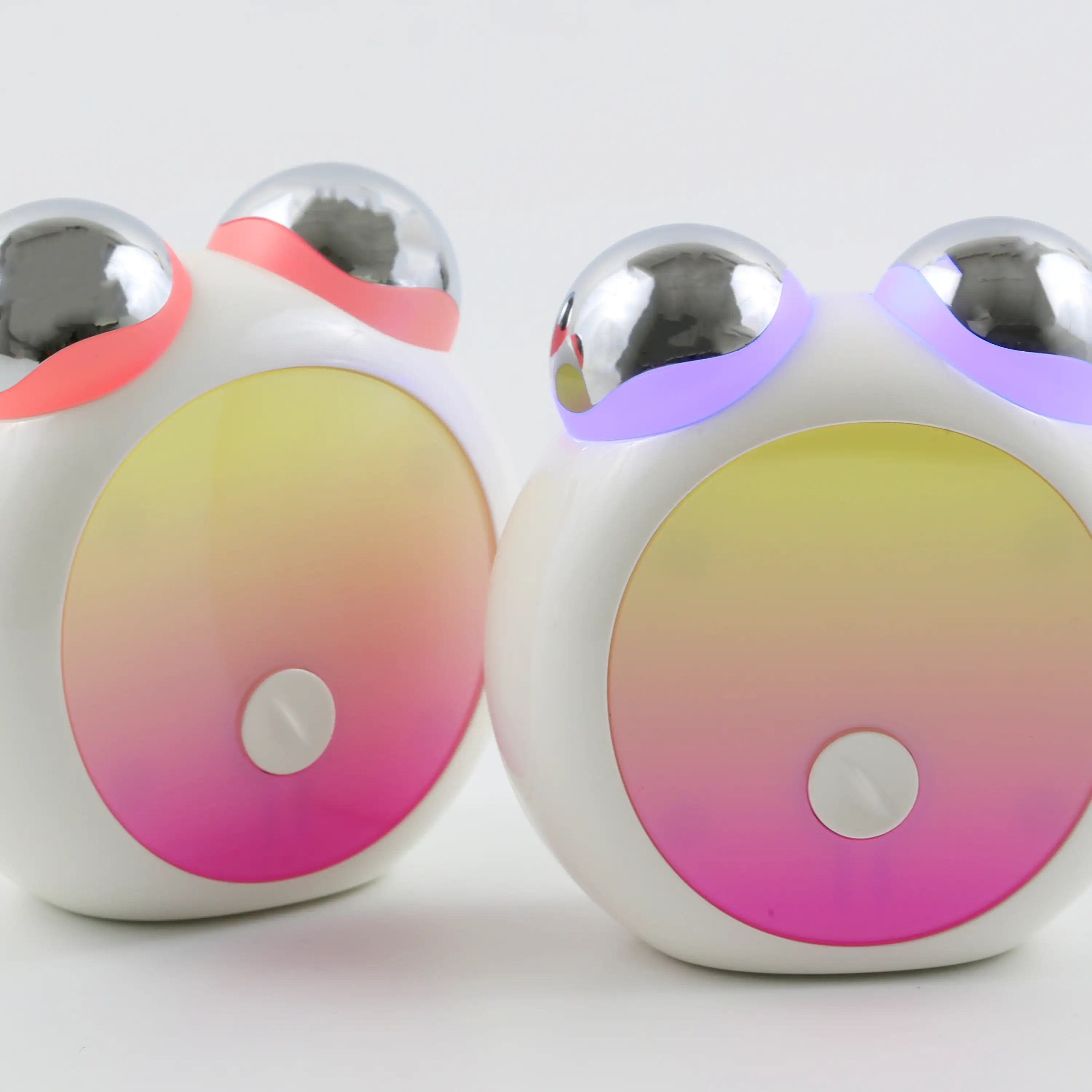 Pair of Compact LED Facial Toning Massagers featuring an ergonomic design, visible red and blue LED lights, and high-frequency microcurrent EMS massage rollers.