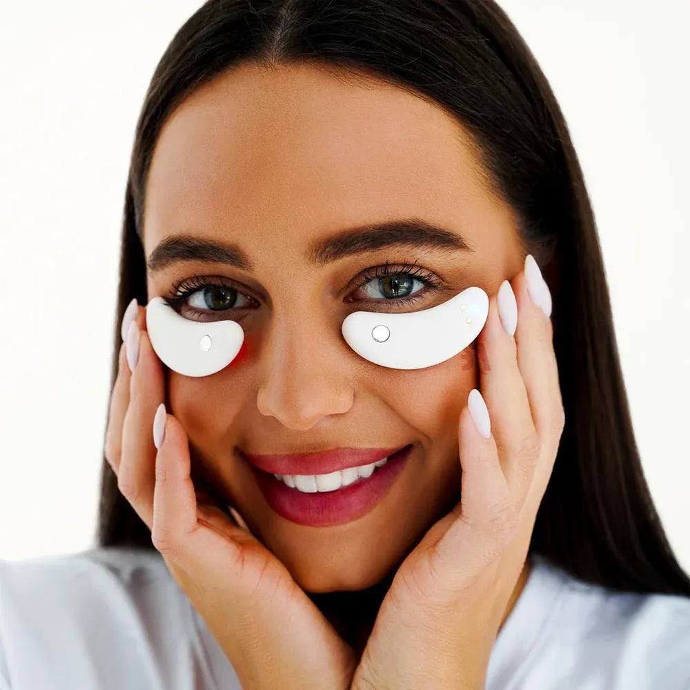 Close-up of model relaxing with GlowUp Eye Pads on under-eye area to reduce puffiness and fine lines.

