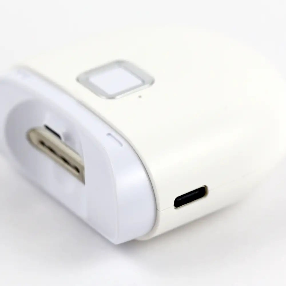 Electric Nail Trimmer laid flat showing the USB‑charging port and compact design.