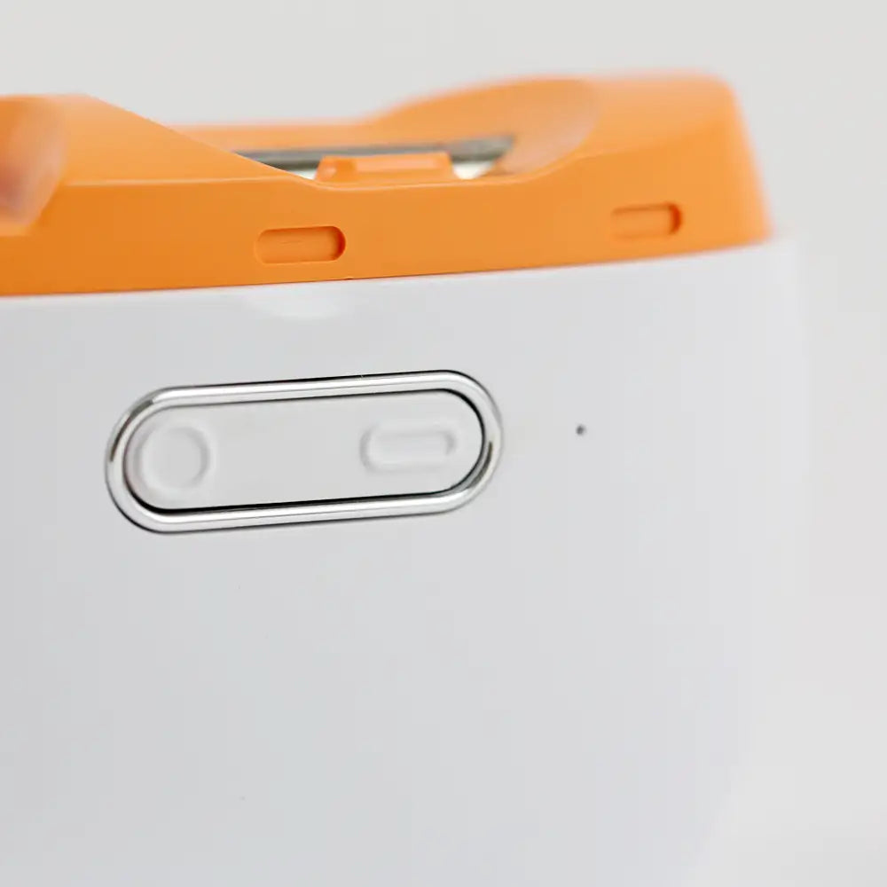 Close-up of the mode and power button of the electric nail trimmer with polisher by re-nū Smart Beauty