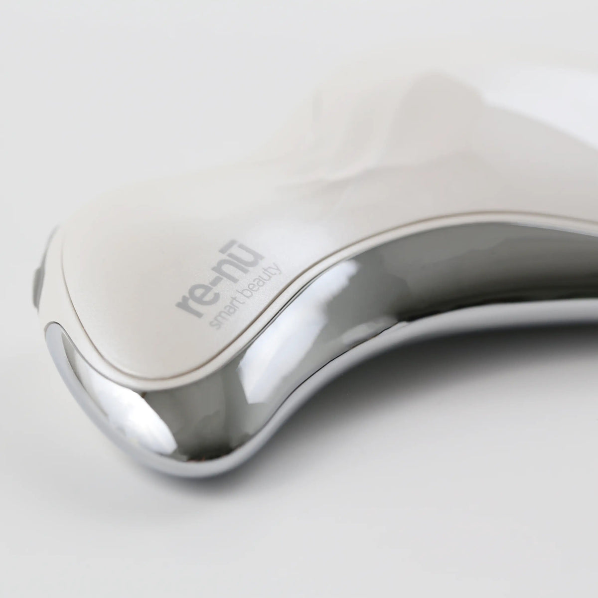 Detailed close-up of the V-shaped edge on the Heated Sonic Gua Sha device, designed to glide along facial contours with precision.