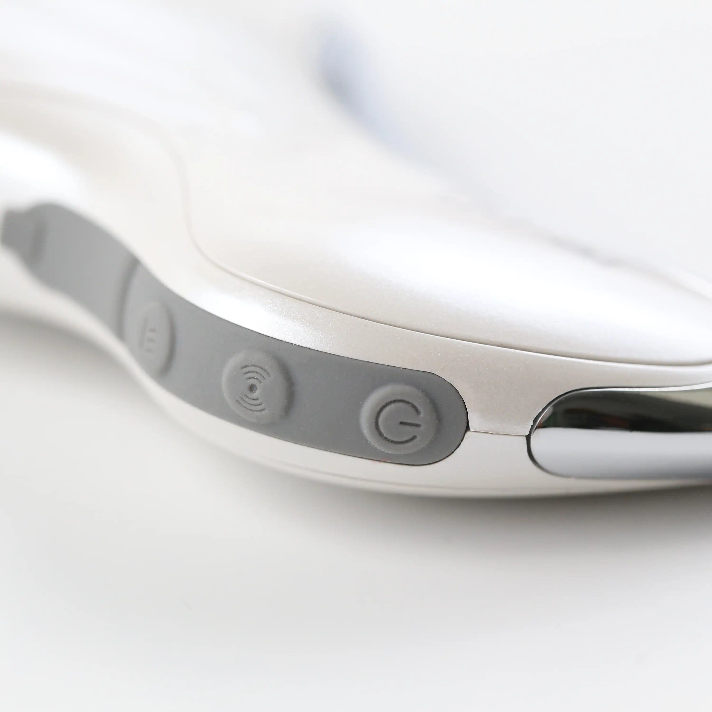 Close-up of the Heated Sonic Gua Sha Facial Massager controls, showing the power button and simple interface for easy operation.