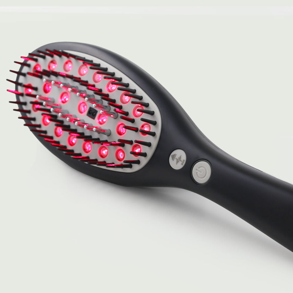 A side angle view of the Laser Hair Growth Brush, showing its ergonomic design for hassle-free daily use  and easy power control.