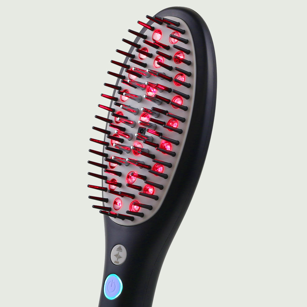 Close-up of red light therapy LED bristles on the Laser Hair Growth Brush, designed to stimulate scalp circulation and hair follicles.