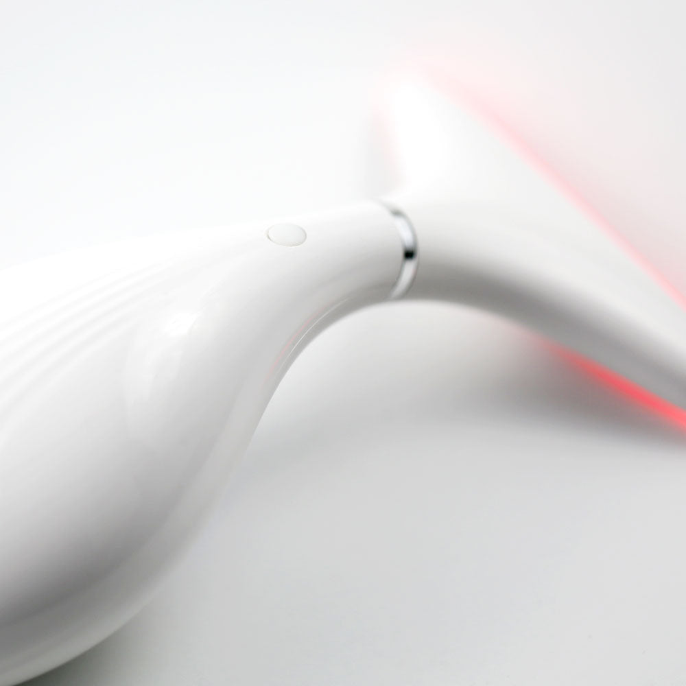Close-up of control button and sculpted ergonomic frame of 360° LED Lift & Sculpt  showing user-friendly interface and contoured design for neck and jawline