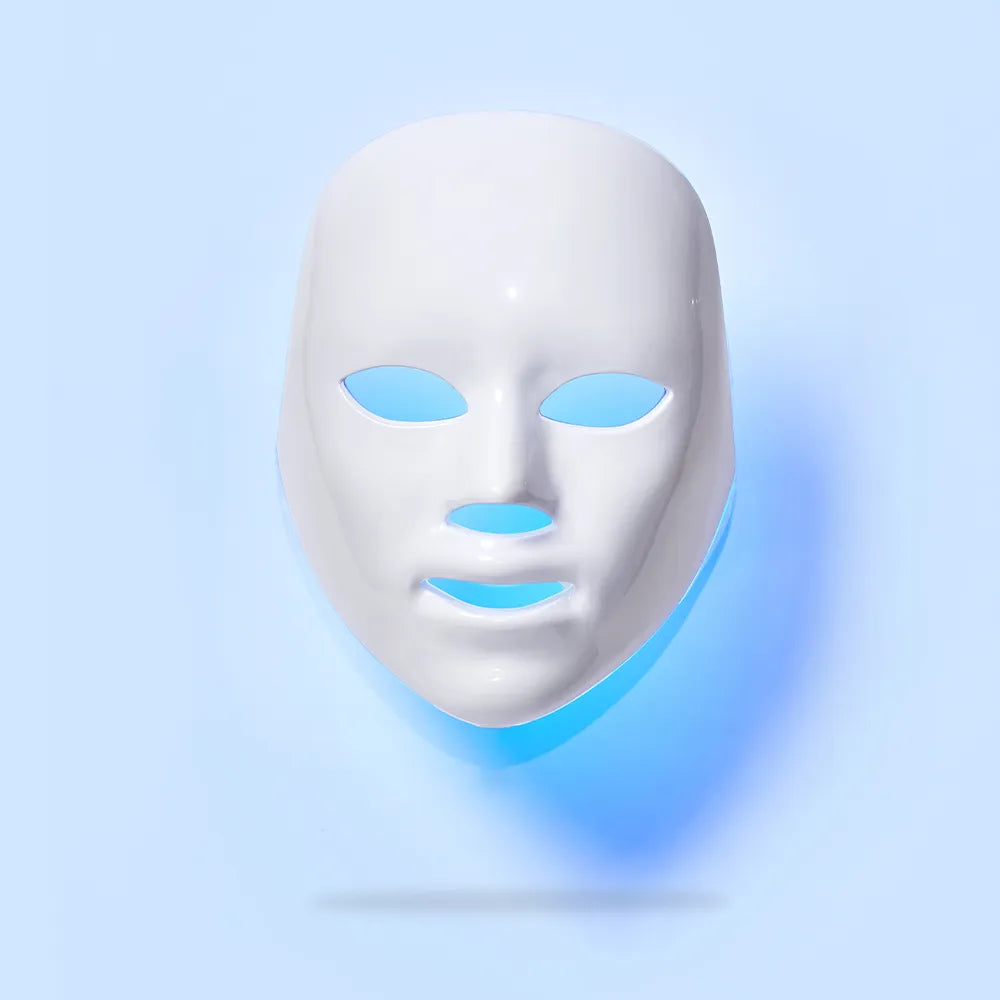 LED light therapy facial mask with blue glow, designed to reduce acne, fine lines, and rejuvenate skin tone.