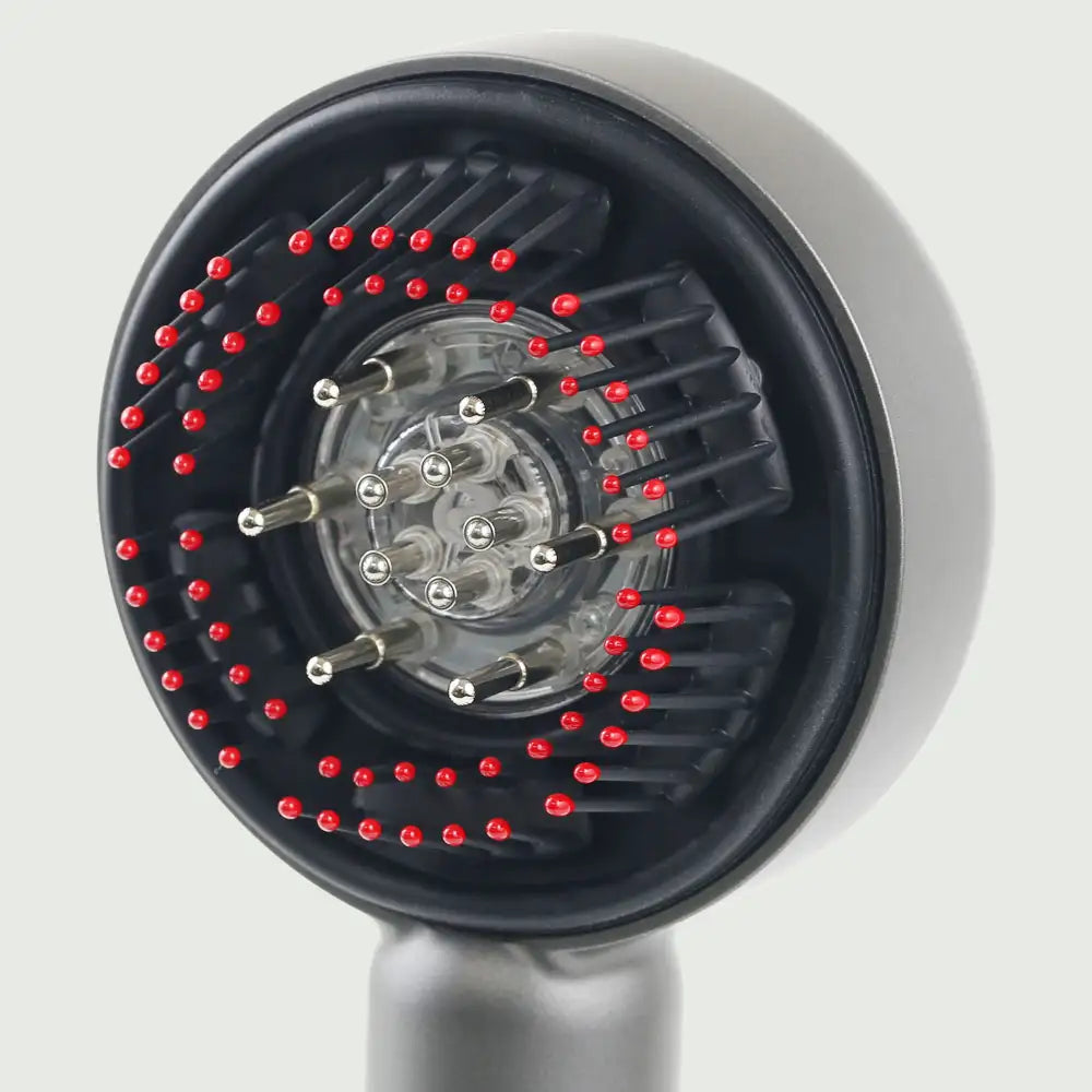 Closeup view of the LED Therapy Massage Comb showing bristles and essential oil ports for robust hair growth.