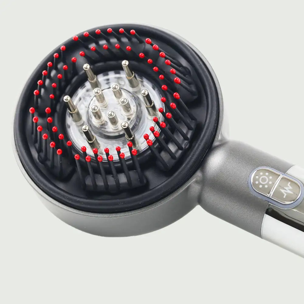 Closeup side view of the LED Therapy Massage Comb showing bristles and essential oil ports for robust hair growth.