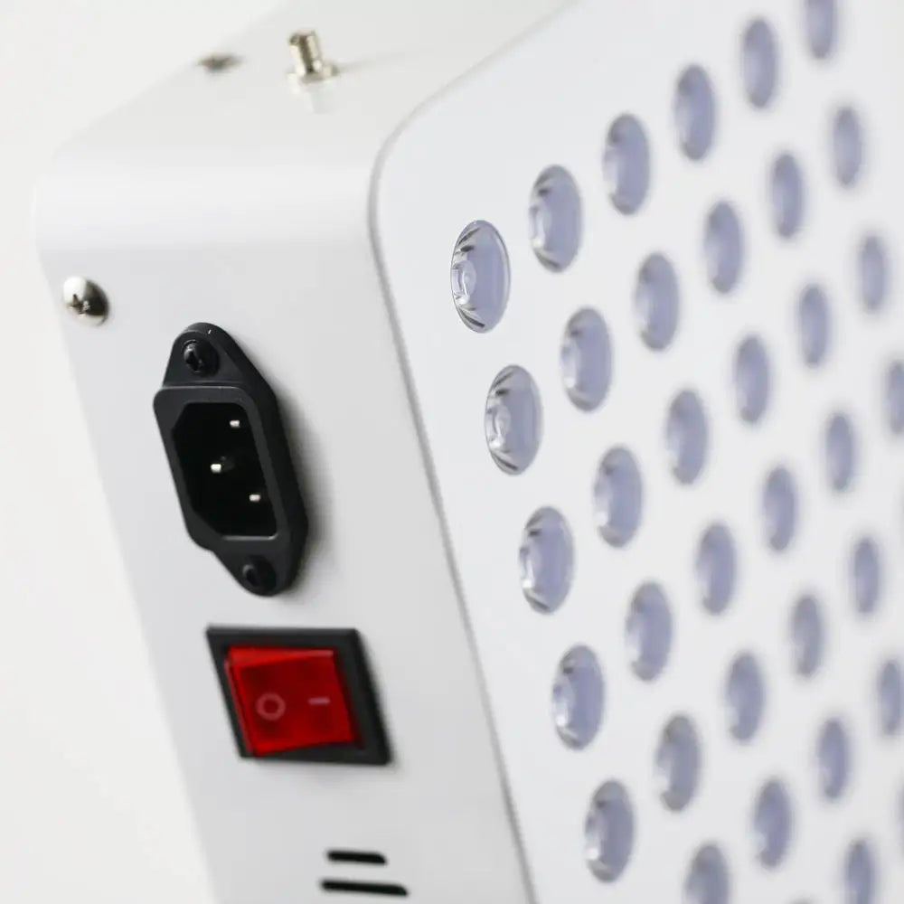 Closeup view of the Red Light Therapy Panel Pro on its adjustable stand, showing the power port, switch, and light diodes.