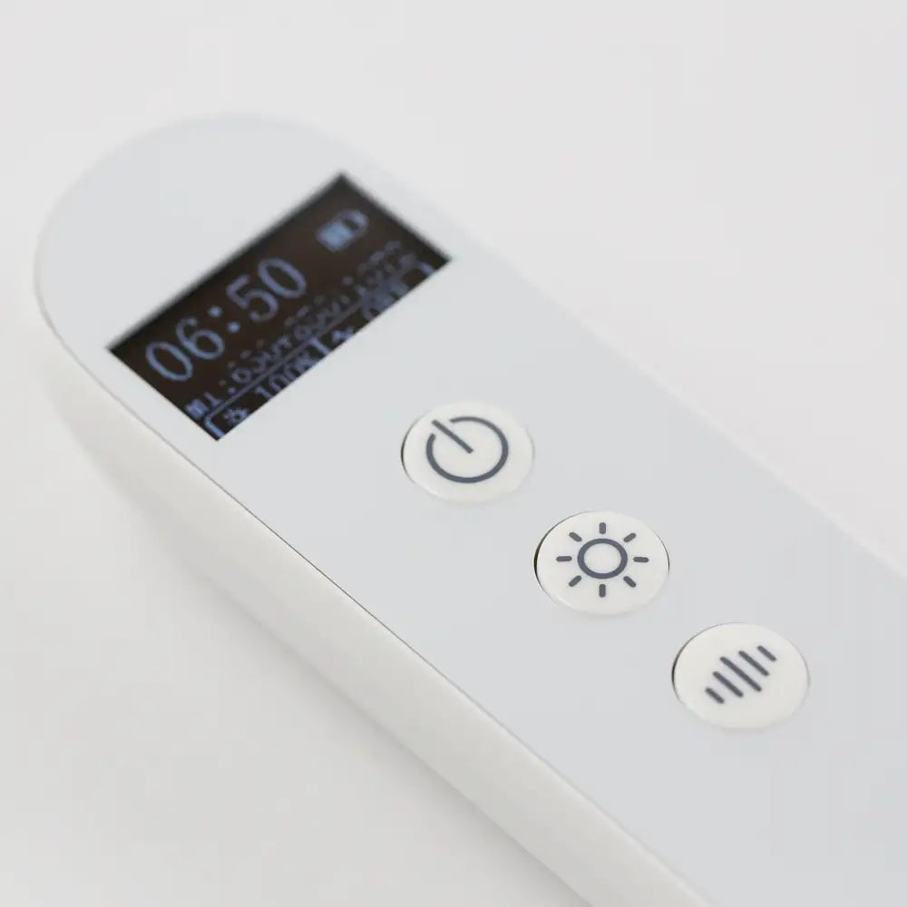 Extreme close-up of the re-nū LED Mask controller showing detailed controls and buttons