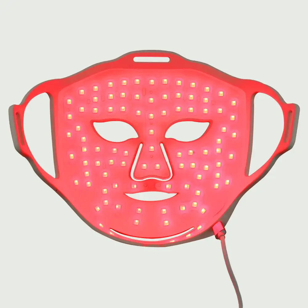 re-nū Liquid Silicone LED Mask illuminated bright red during light therapy mode